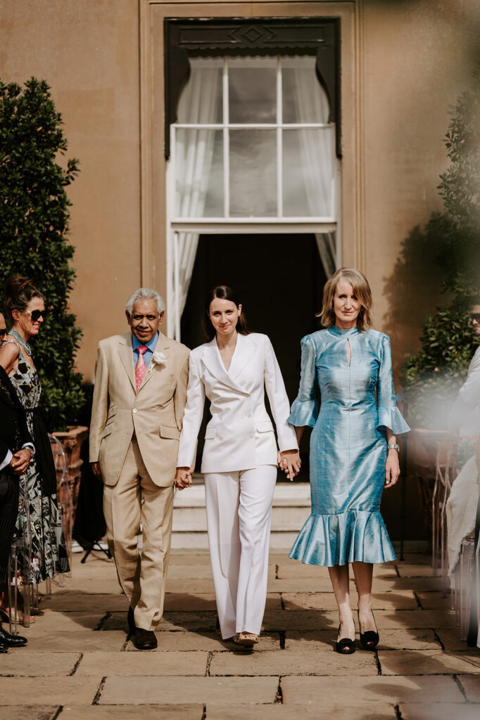 bride and parents walking down aisle