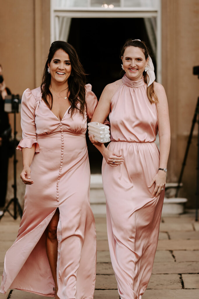 bridesmaids smiling walking down the aisle