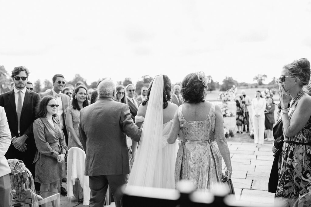 bride walking down aisle with parents
