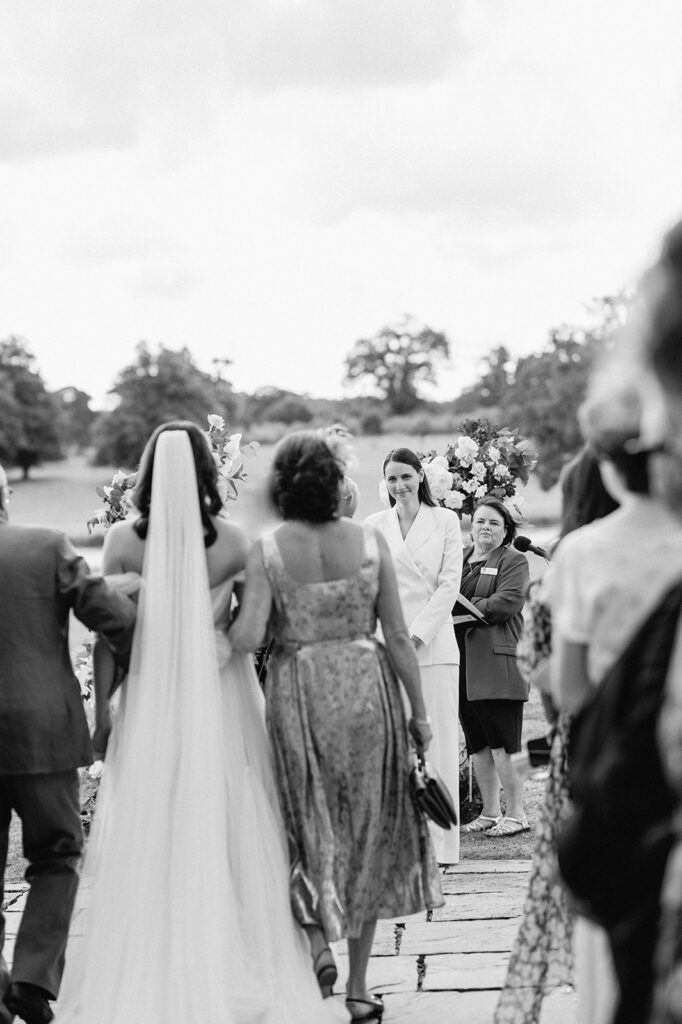bride walking down aisle with parents