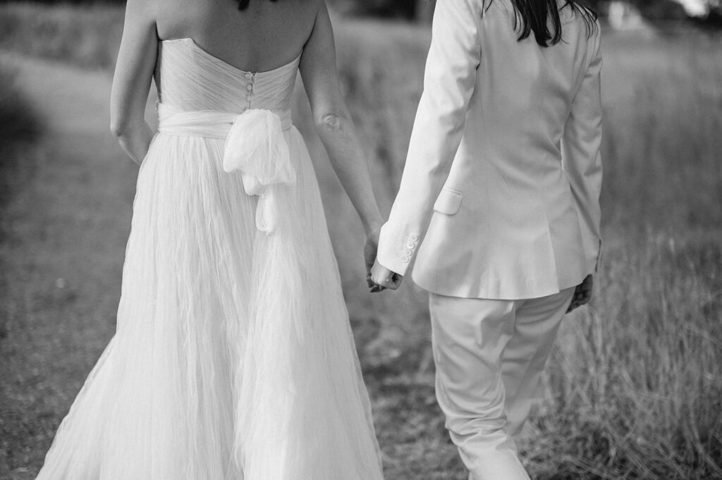 two brides walking hand in hand