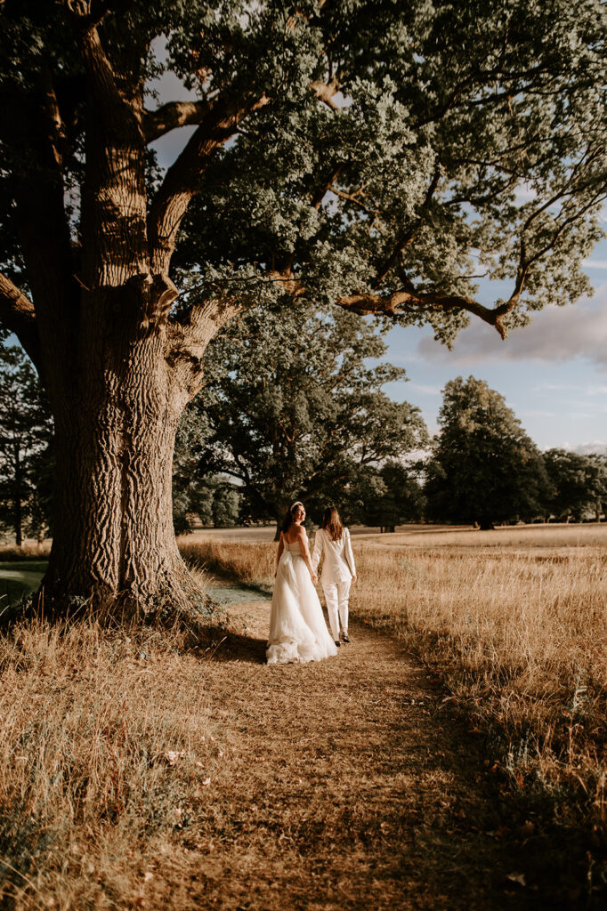 two brides at sunset walking away