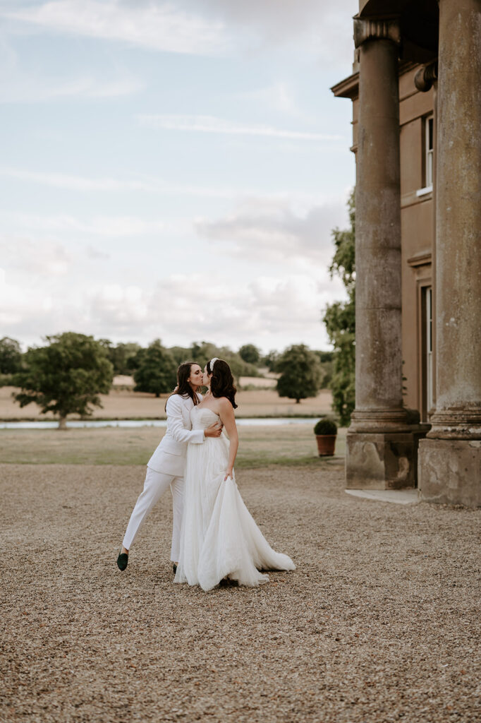 brides kissing outside sibton park on gravel
