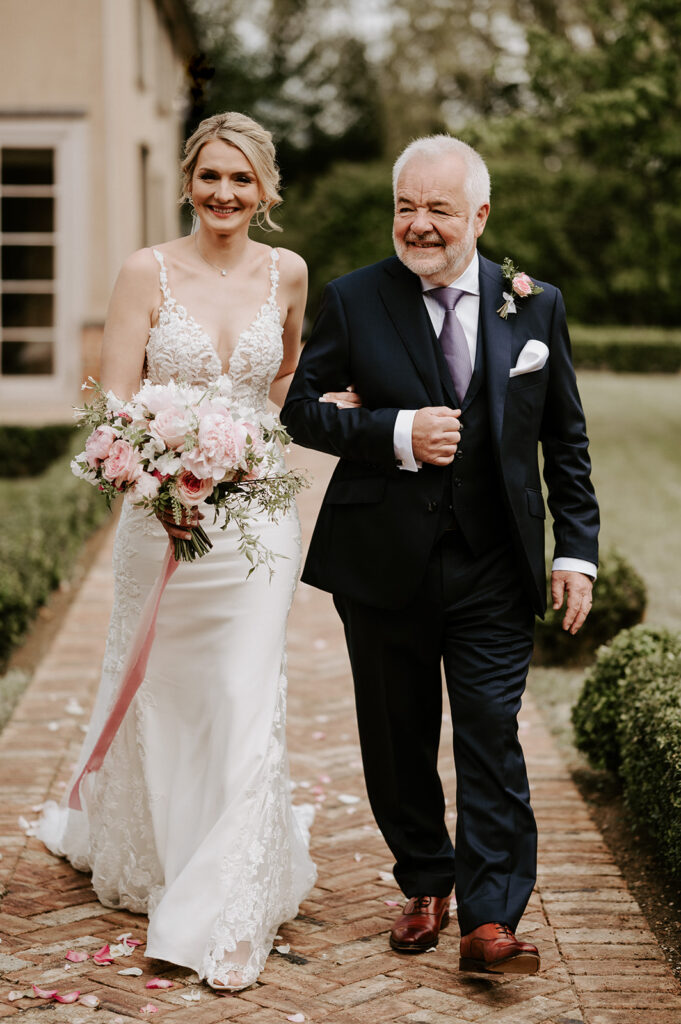 bride walking down aisle with father at retreat east