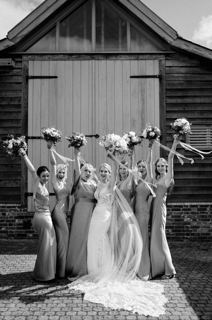 bride wearing Martina liana dress with bridesmaids and peony bouquets at retreat east