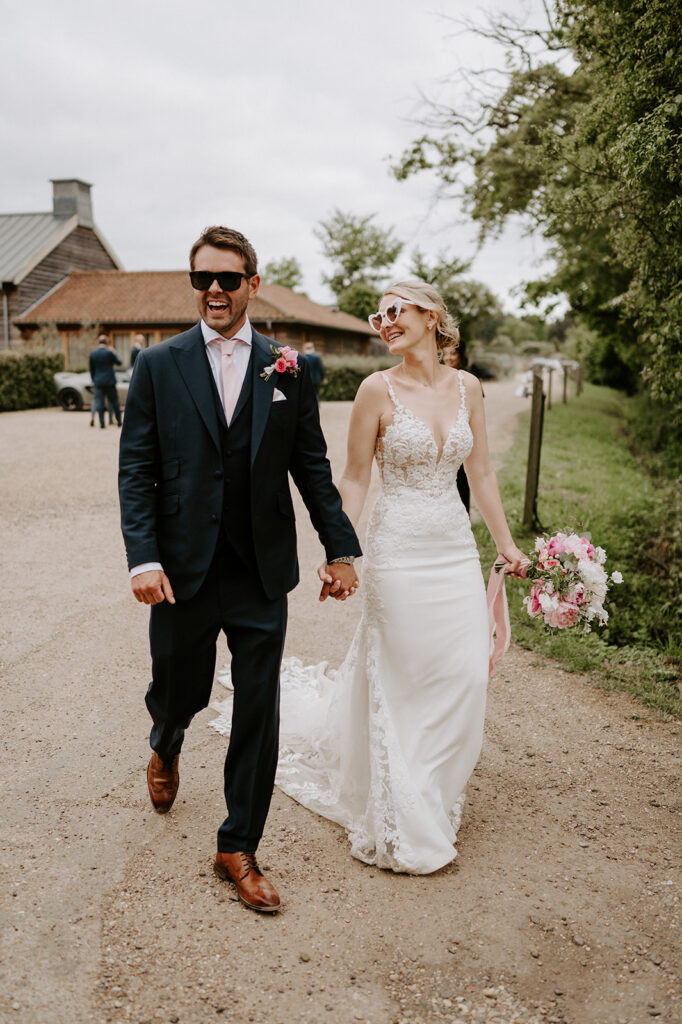 couple walking wearing sunglasses at retreat east