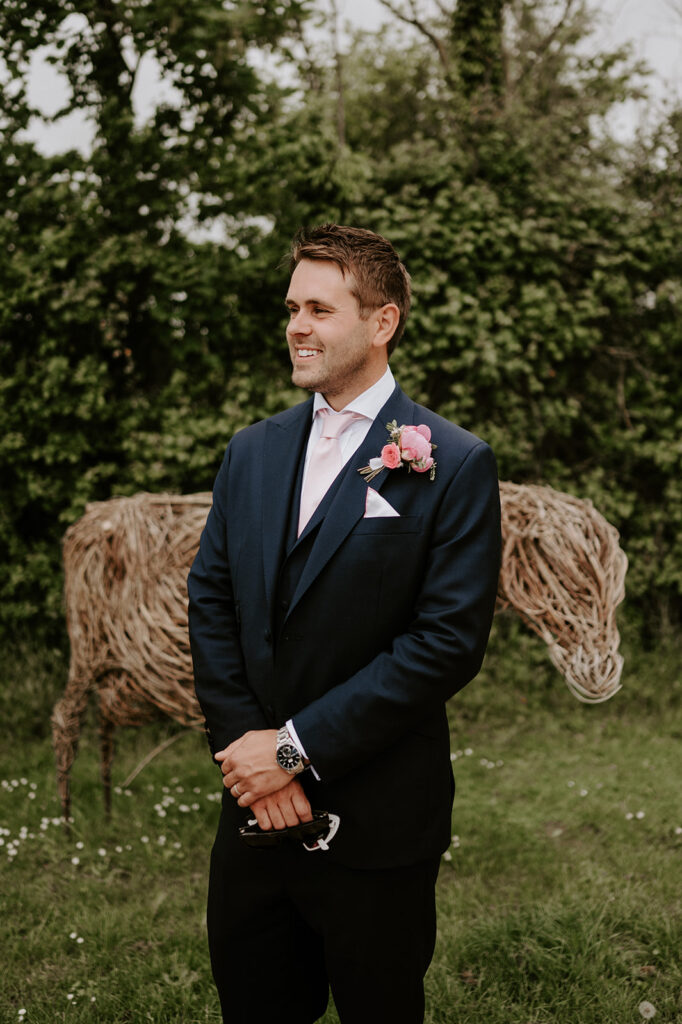 groom wearing navy blue wedding suit