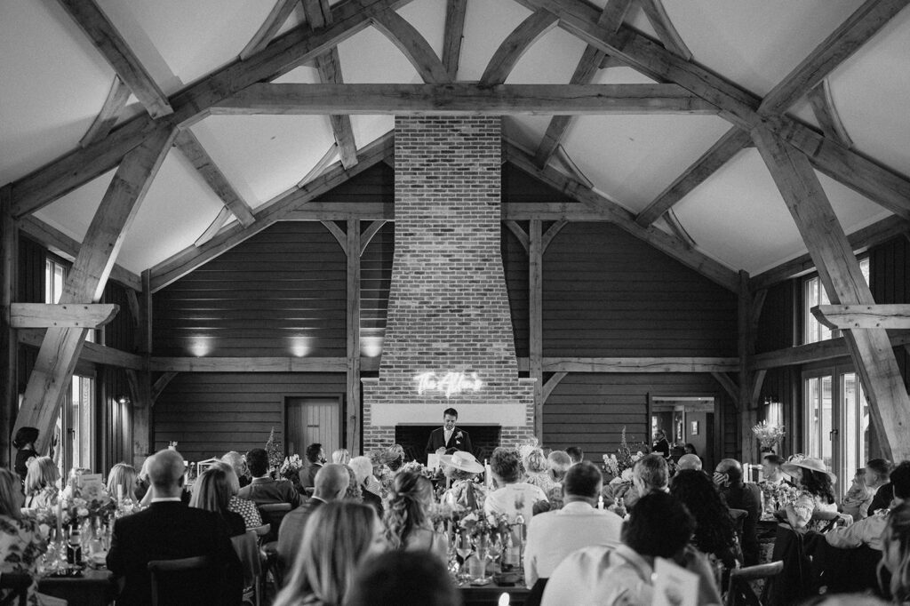 groom giving speech in the great barn at retreat east