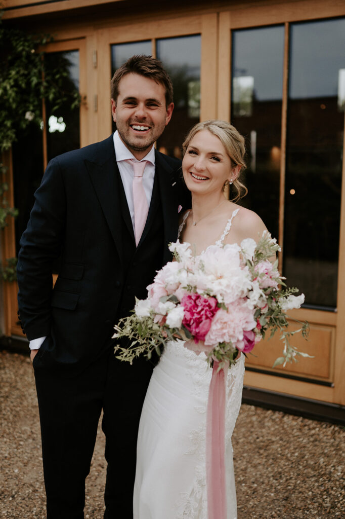 couple standing outside the great barn at retreat east
