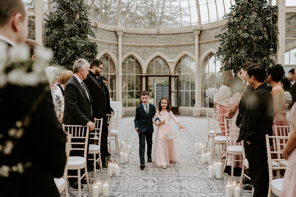 flower girl and boy walking down aisle