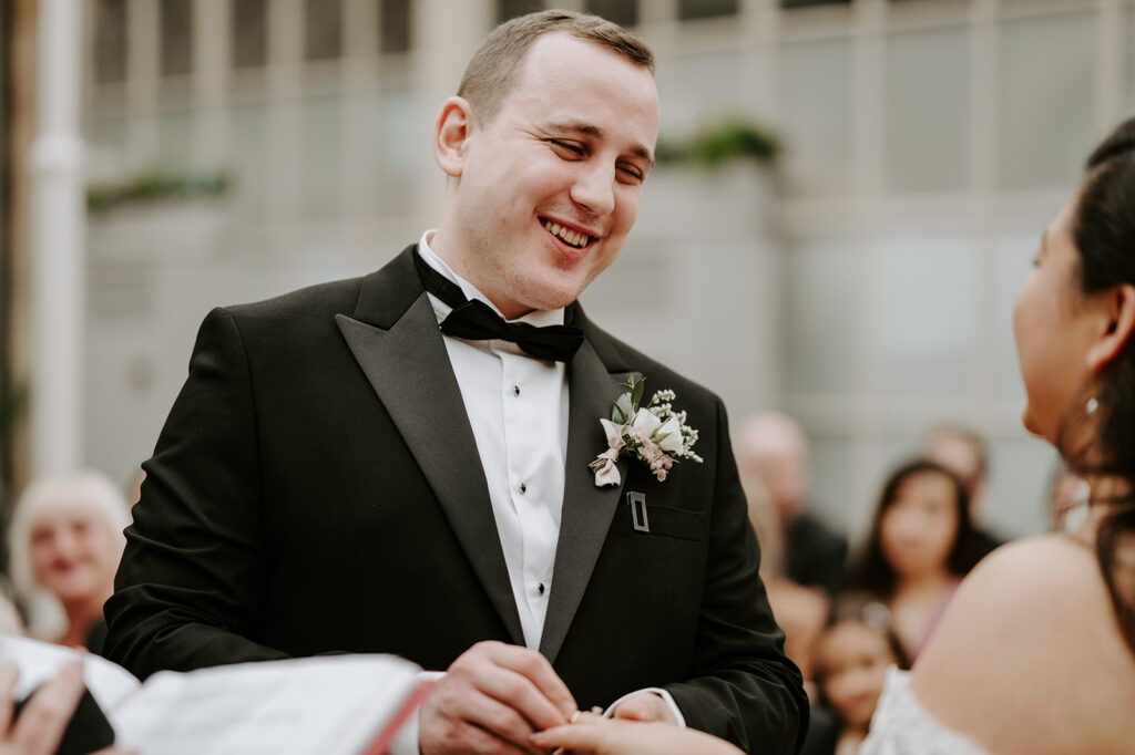 bride and groom exchanging rings at tortworth court