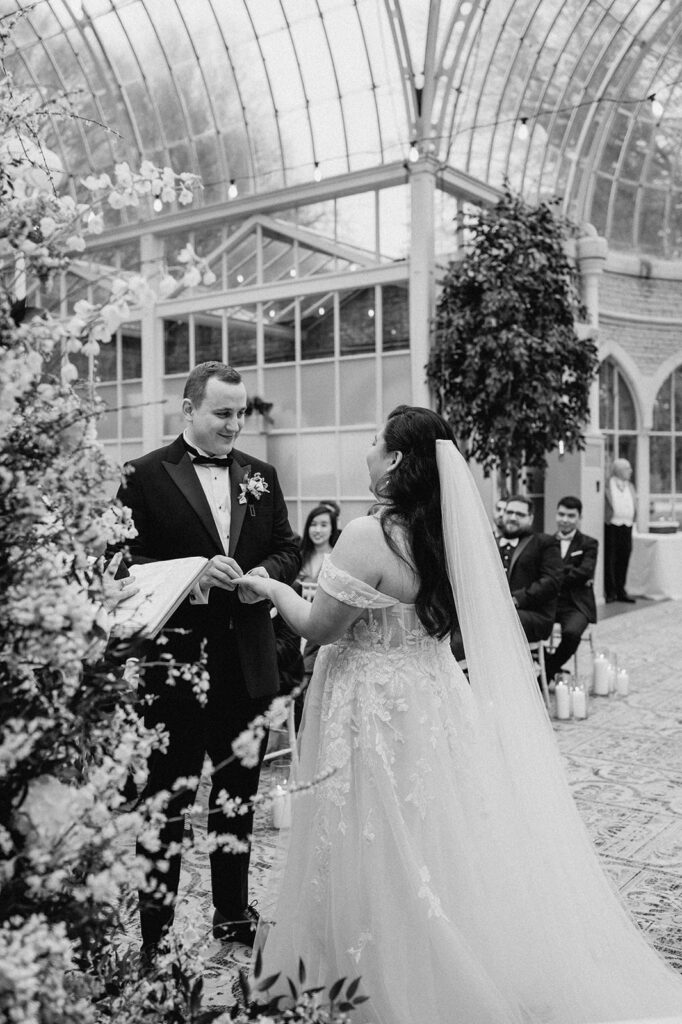 bride and groom exchanging rings during ceremony