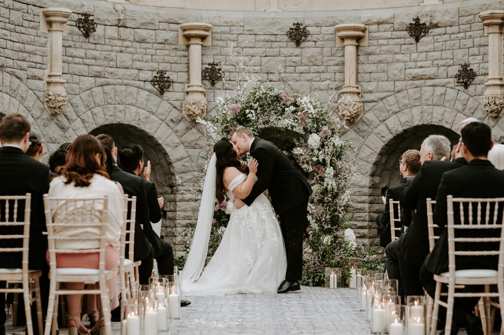 bride and groom sharing first kiss at tortworth court