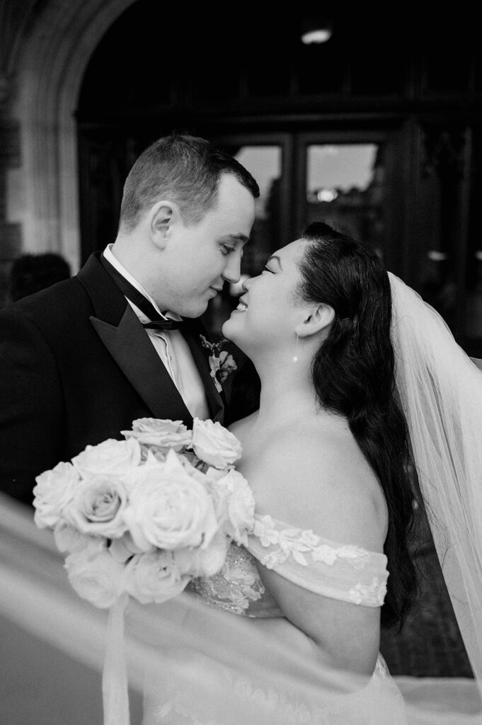 bride and groom with veil floating in wind