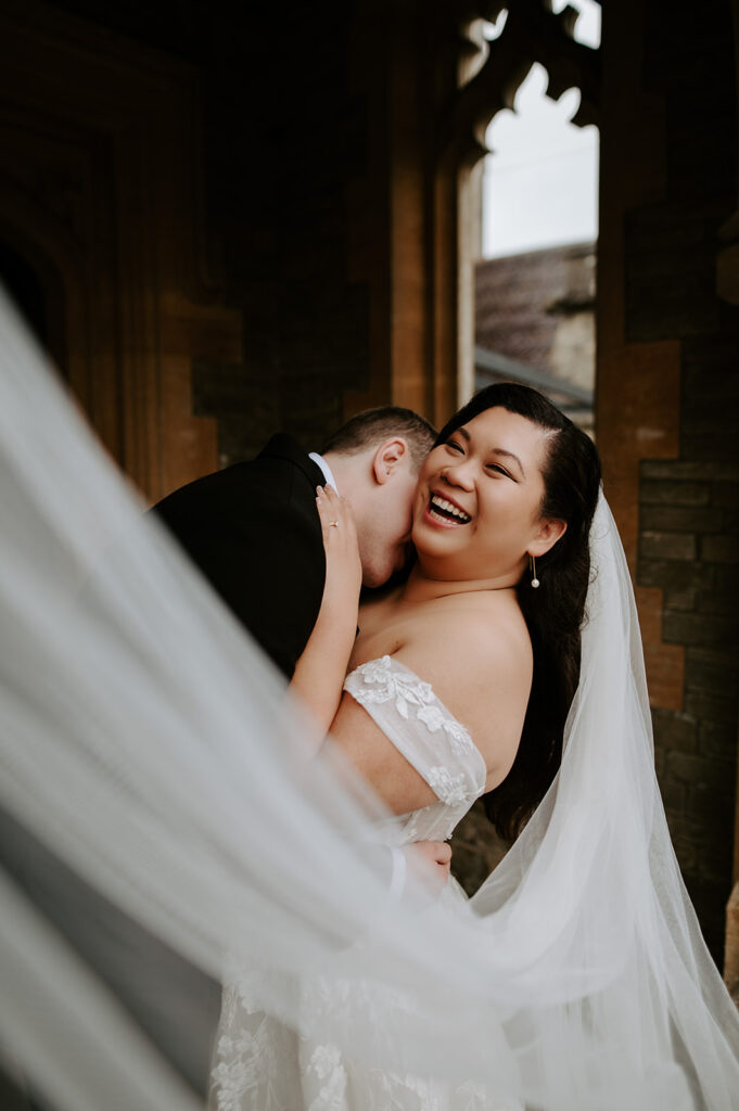 bride and groom with veil