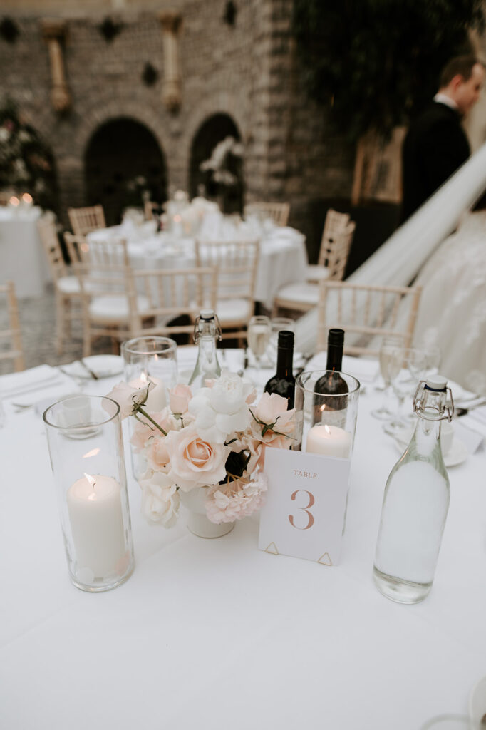 reception table details with blush pink florals and candles