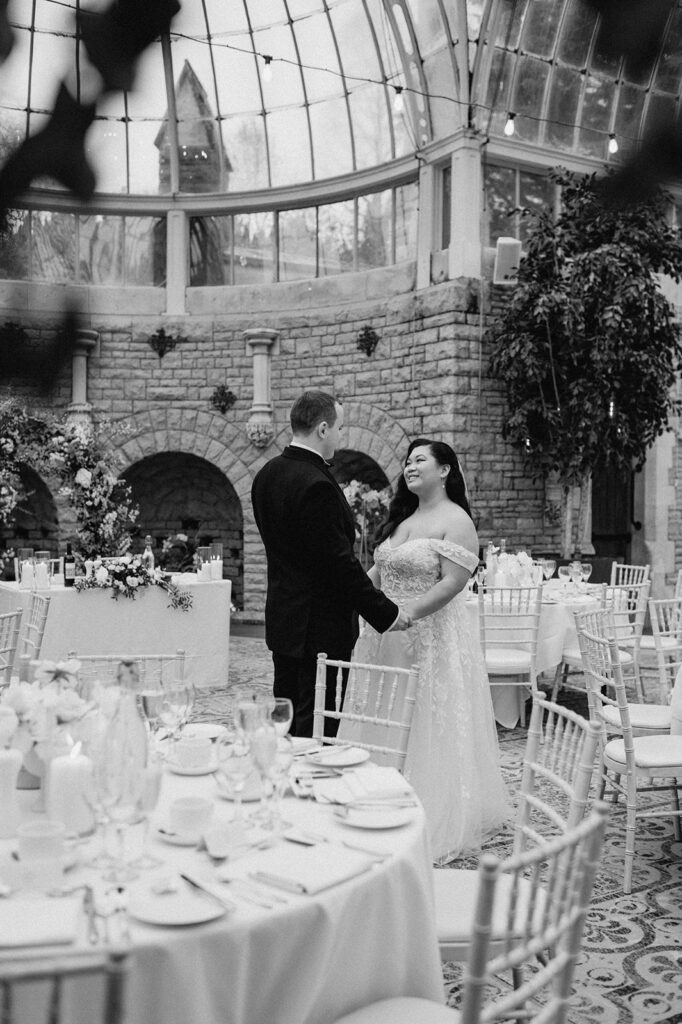 bride and groom in wedding breakfast set up in orangery at tortworth court
