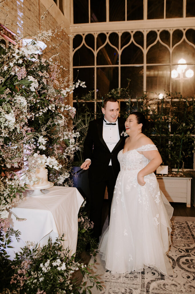 bride and groom cutting the wedding cake at tortworth court