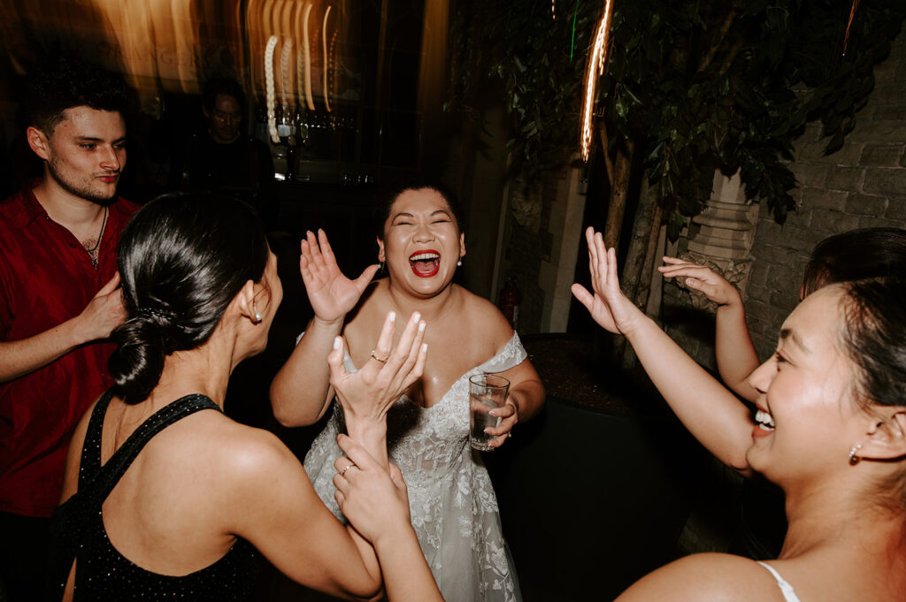 bride dancing with guests on dance floor at tortworth court