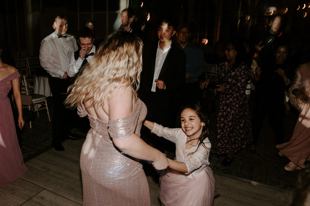 flower girl dancing on dance floor at tortworth court