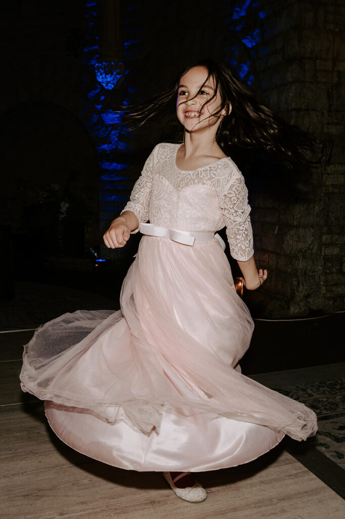 flower girl dancing on dance floor at tortworth court