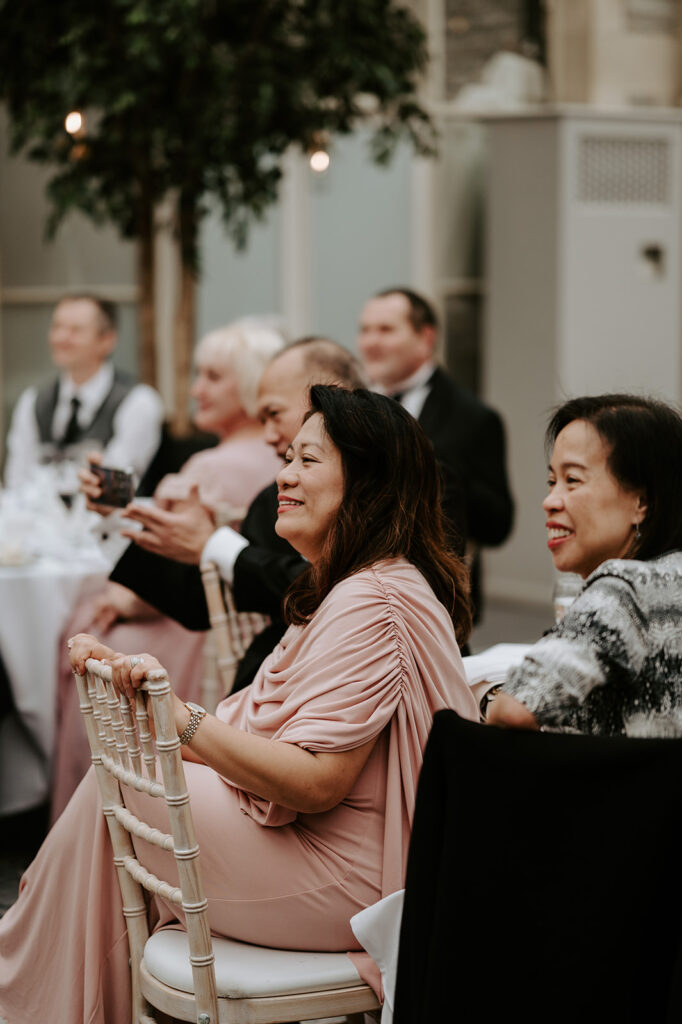 guests laughing at wedding speeches 
