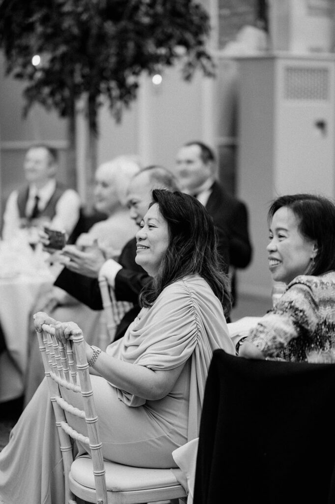 guests laughing at wedding speeches 