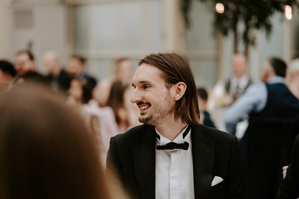 guests laughing at wedding speeches 