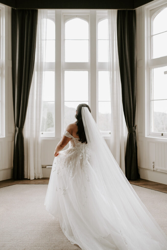 bride by window at tortworth court