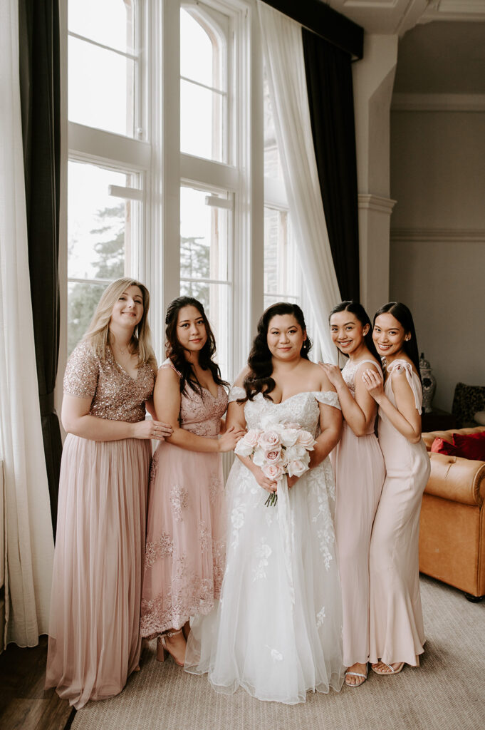 bridesmaids in blush pink with bride at tortworth court