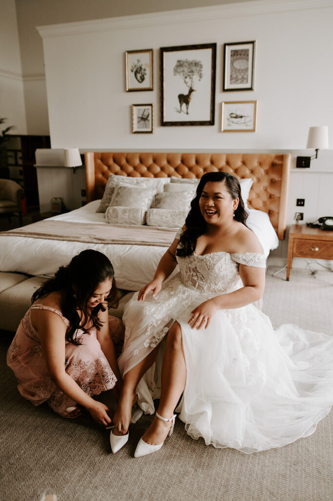 bride putting shoes on at tortworth court