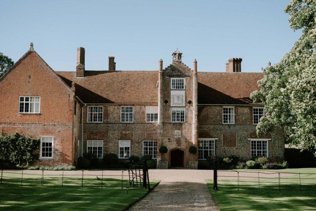 Exterior of Bruisyard Hall in summer light during the wedding day