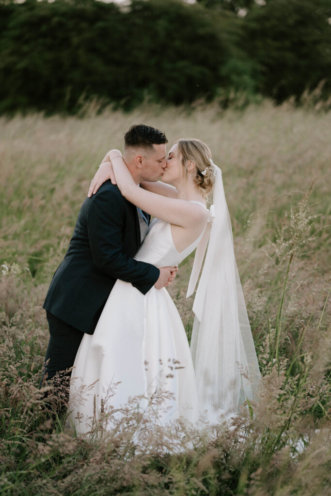 bride and groom kissing at bruisyard hall