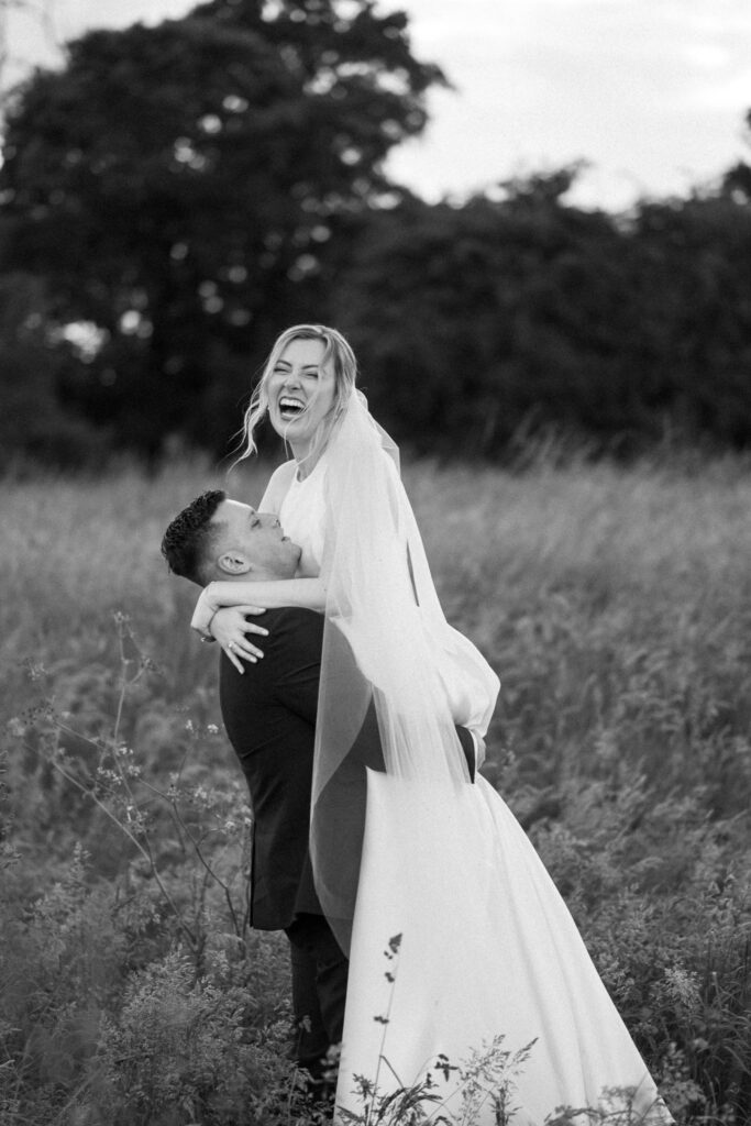 groom picking up bride and bruisyard hall
