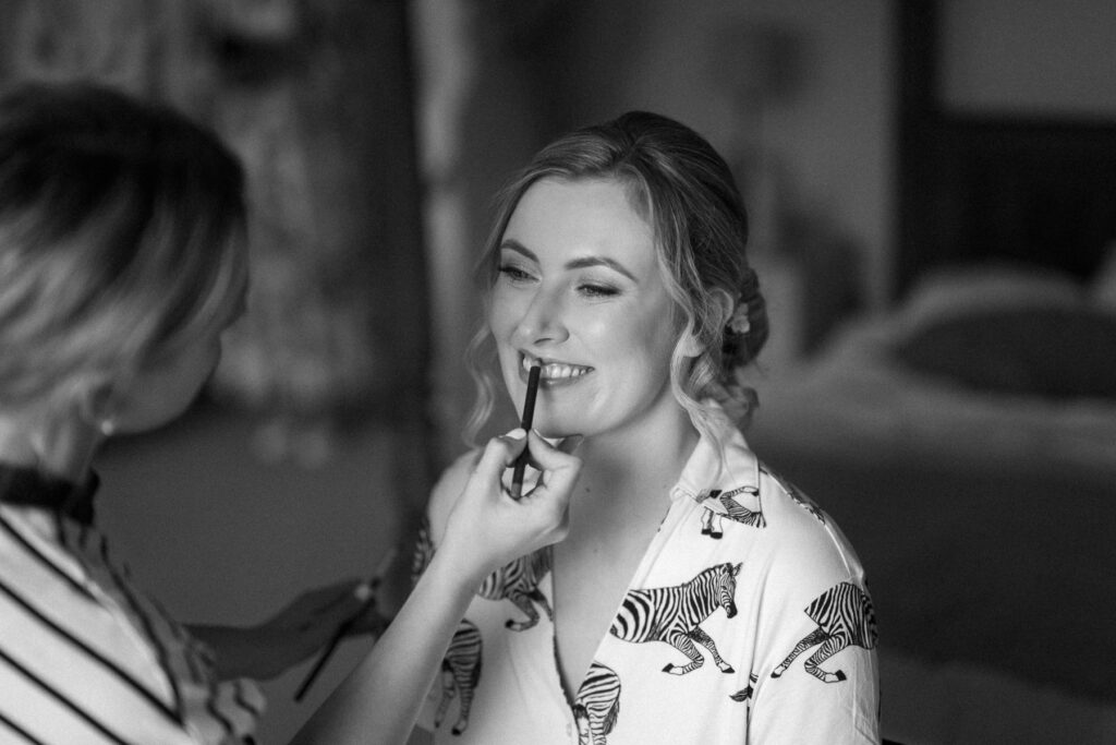 bride having her makeup applied during bridal prep