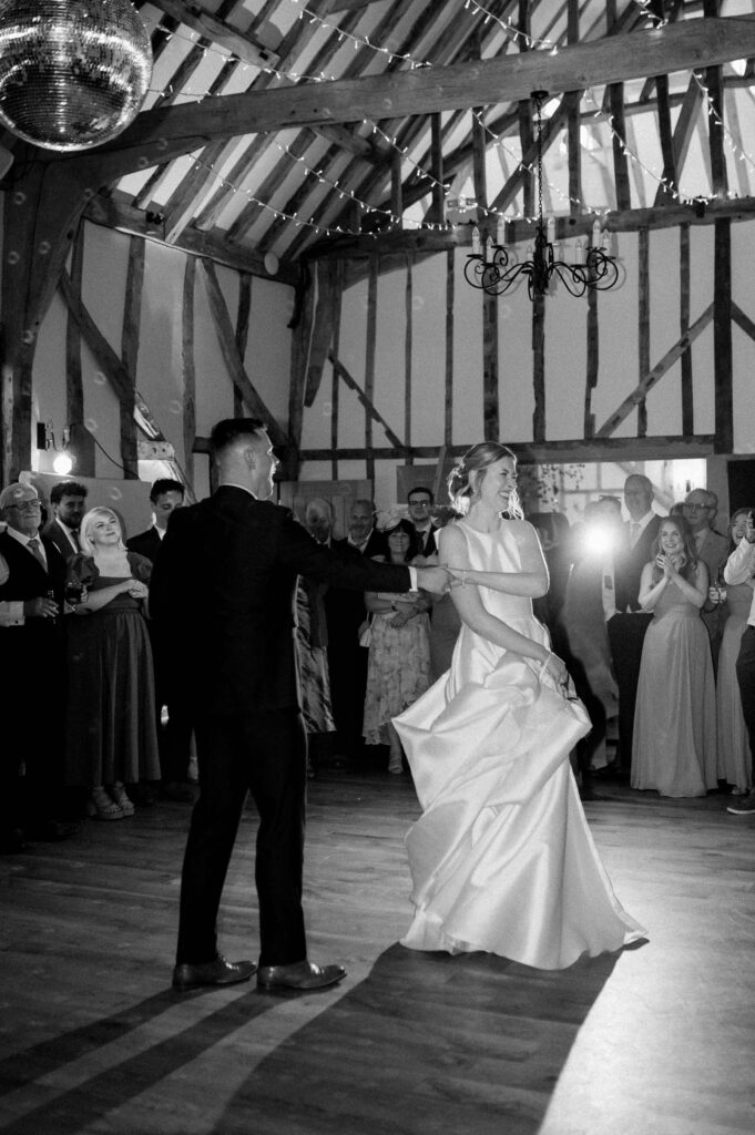 Bride twirling on the dance floor during the evening reception at Bruisyard Hall