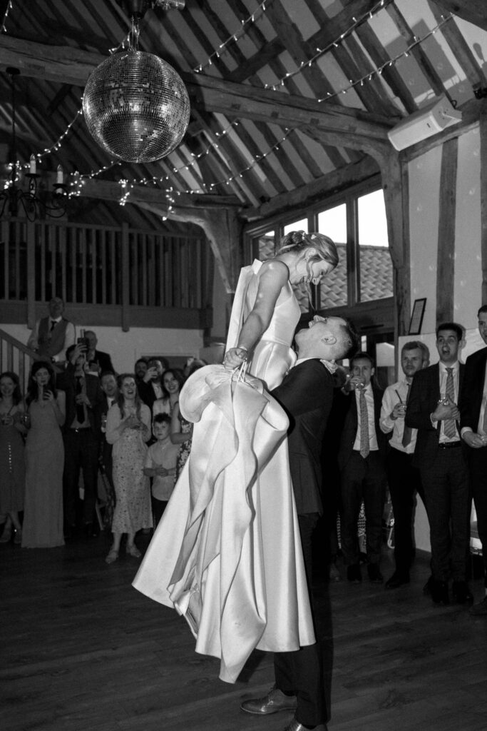Groom lifting the bride during the first dance at Bruisyard Hall