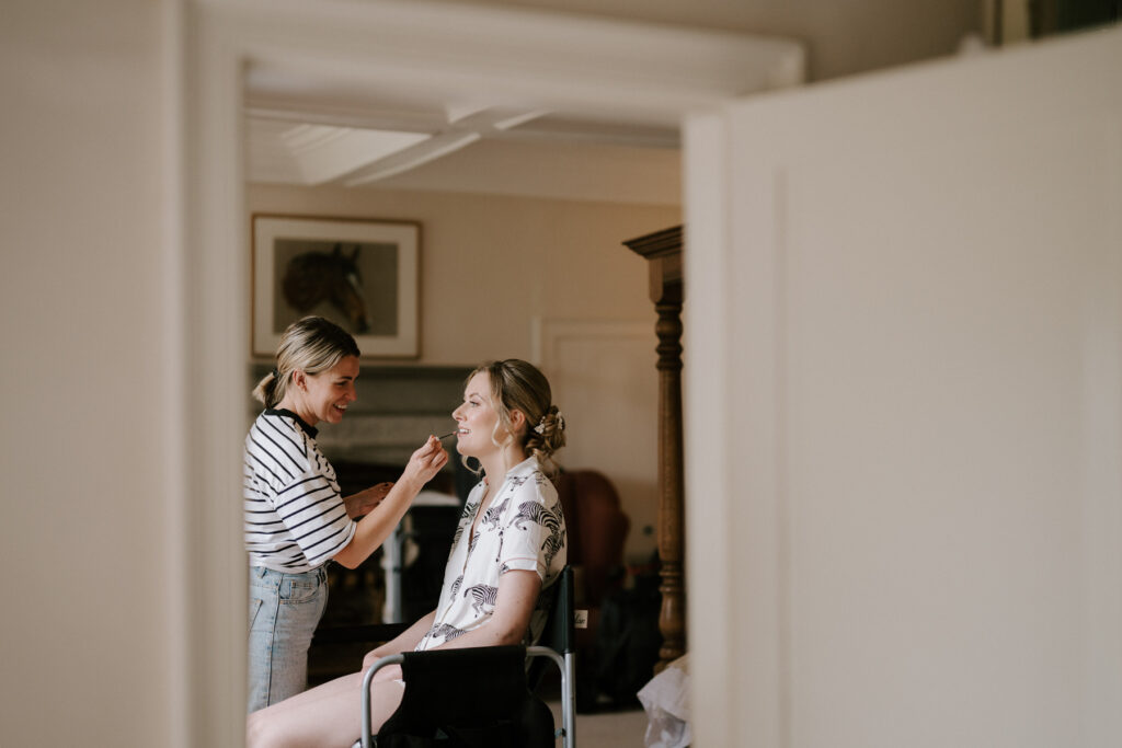 bride having her makeup applied during bridal prep