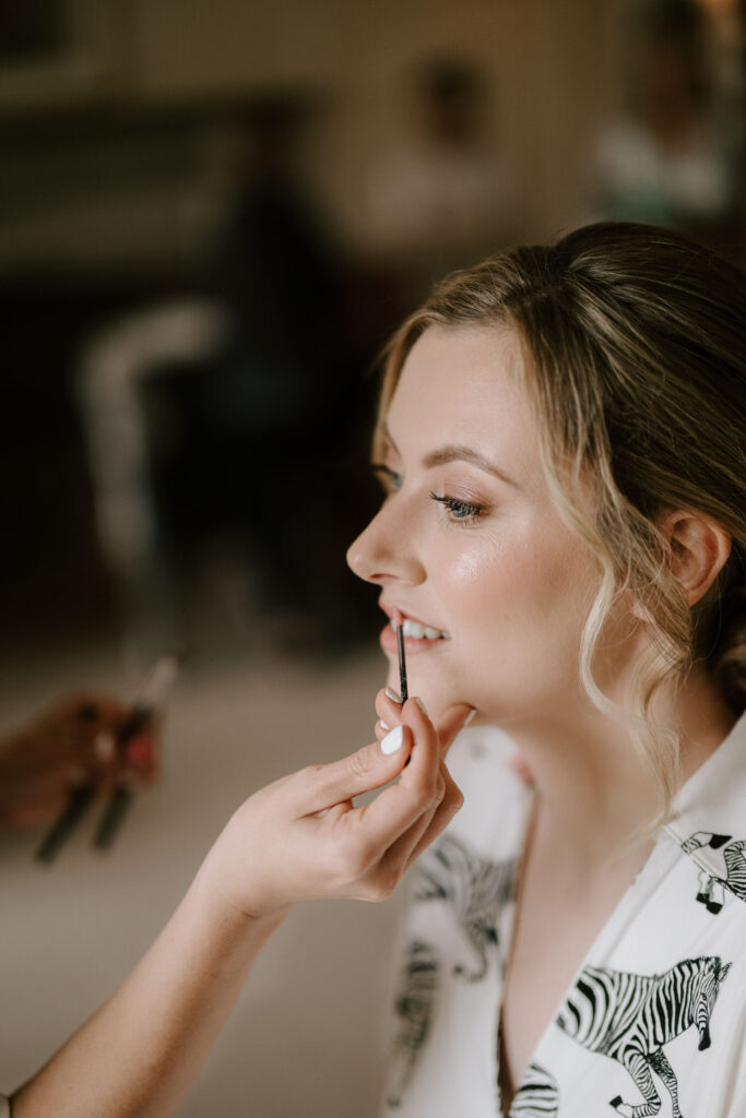 close-up of bride having her makeup applied during bridal prep