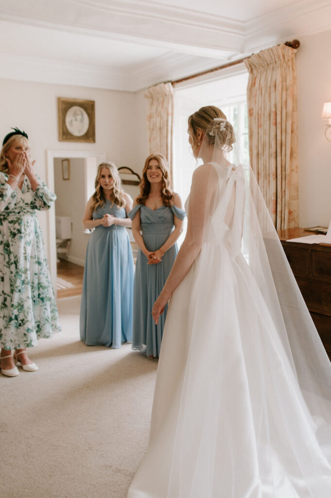 Bride standing with her bridesmaids in the prep room at Bruisyard Hall