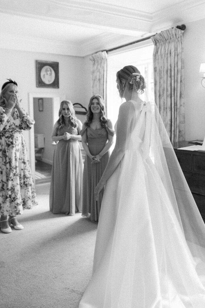 Black and white photo of bride Heidi with her bridesmaids during bridal prep at Bruisyard Hall