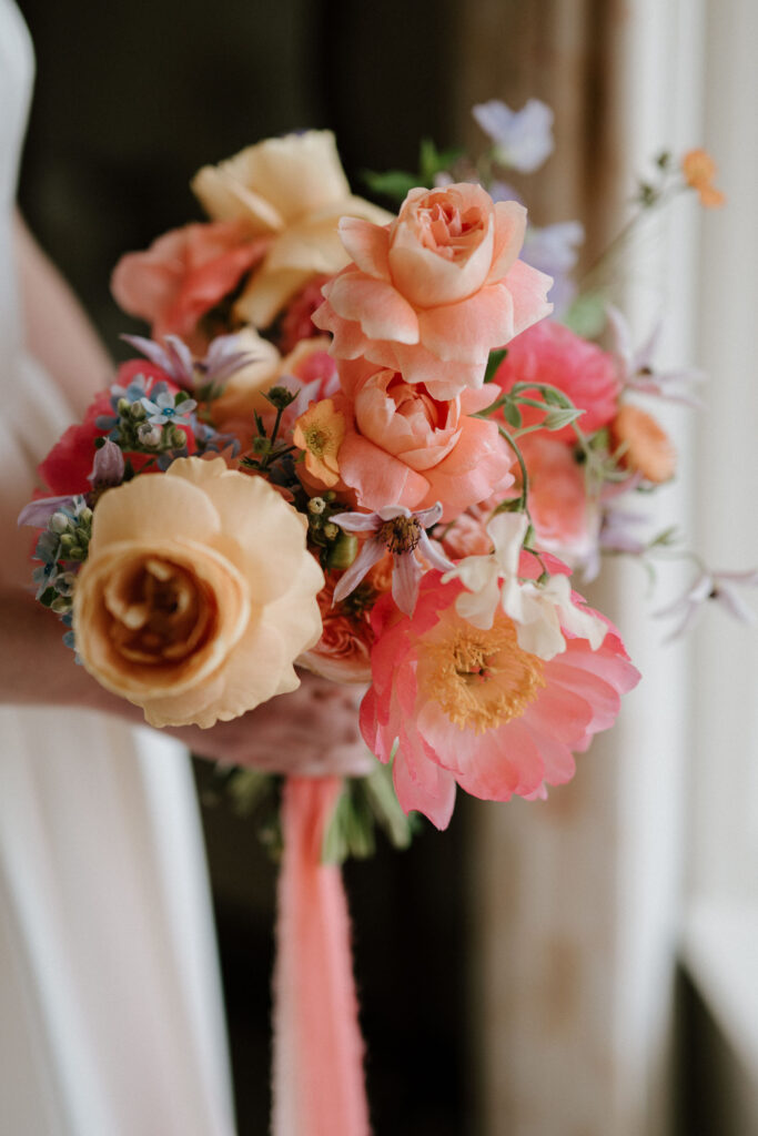 Close-up of bride Heidi’s colourful summer wedding bouquet at Bruisyard Hall