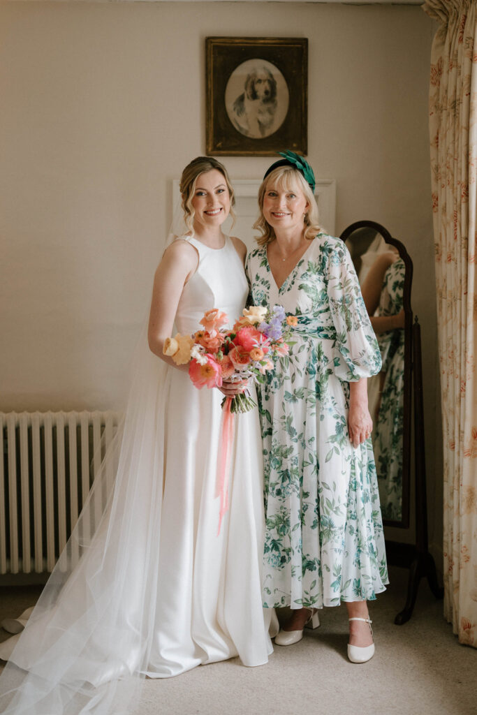 Bride standing with her mum during bridal prep at Bruisyard Hall in Suffolk