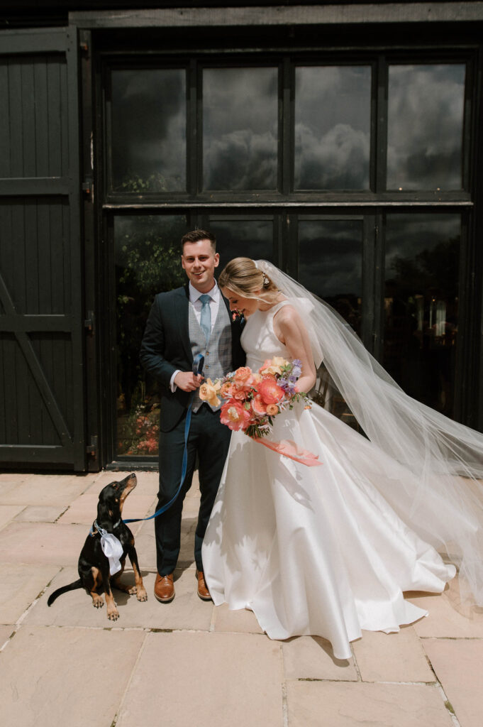 Bride and groom standing together outside after the ceremony at Bruisyard Hall
