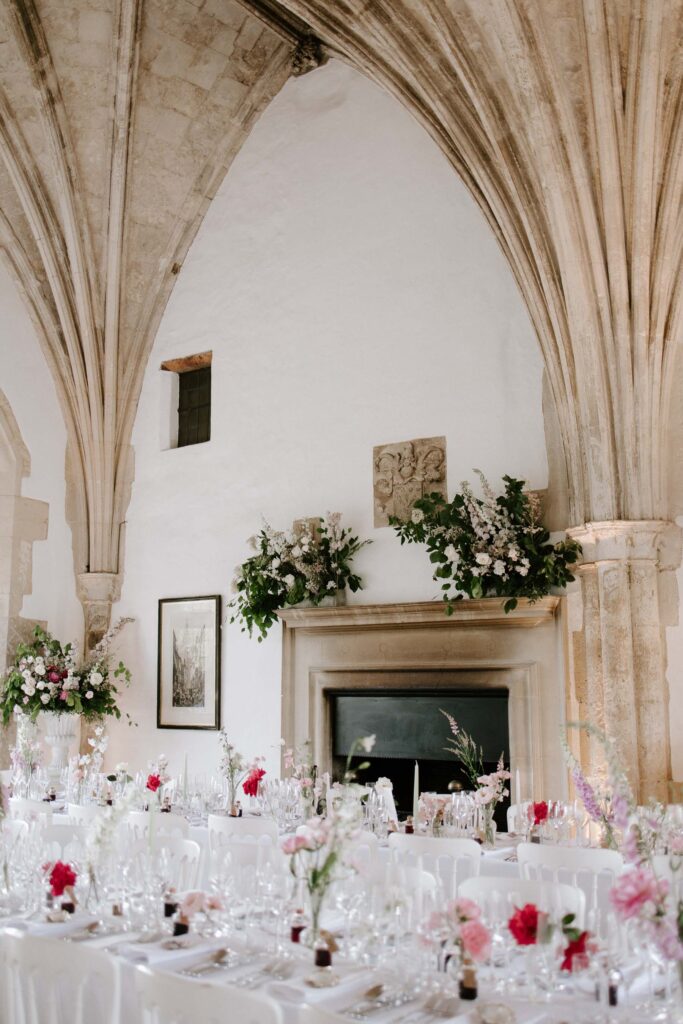 Bride and groom standing together inside the wedding reception room at Butley Priory.
