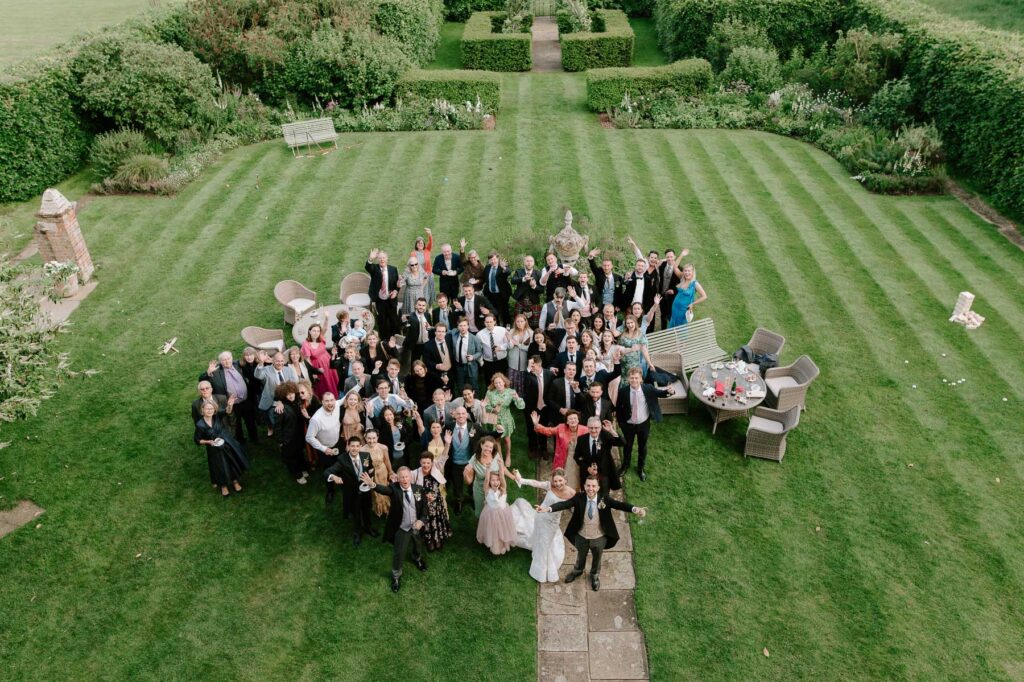 Aerial view of wedding guests gathered together at Butley Priory.
