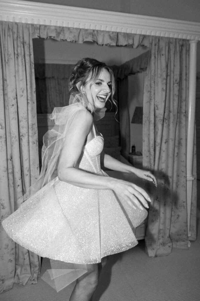 Bride laughing and dancing during the evening reception.