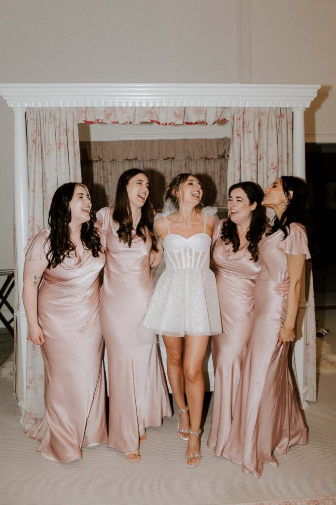 Bride standing with her bridesmaids during evening reception moments.