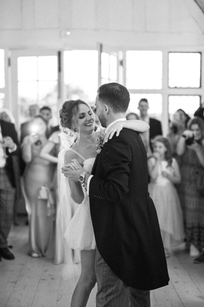 Bride and groom sharing a joyful moment together during evening dancing.