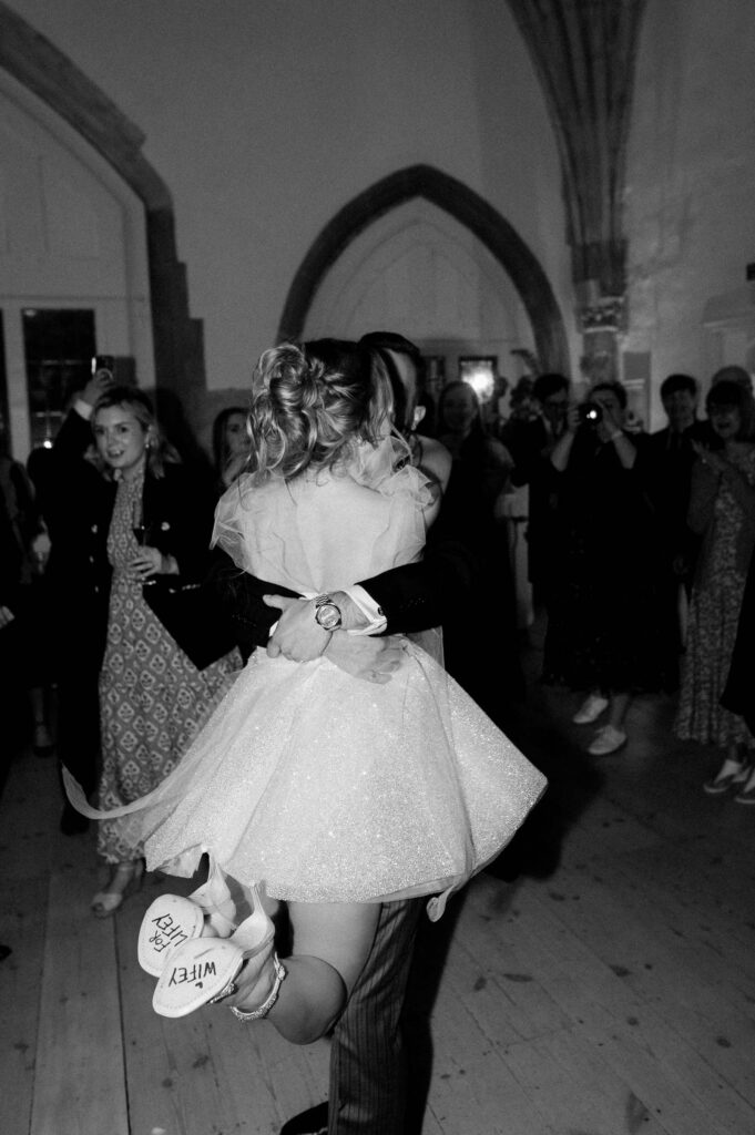 Bride and groom dancing together in the centre of the reception room.